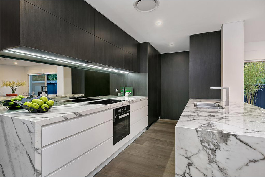 black and white kitchen with marble benchtop