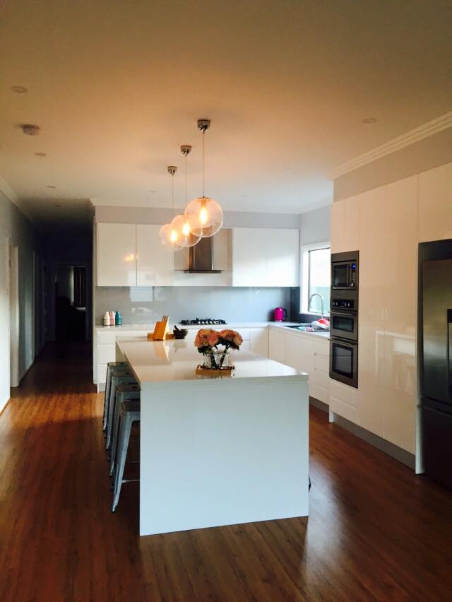 l shaped white kitchen with island